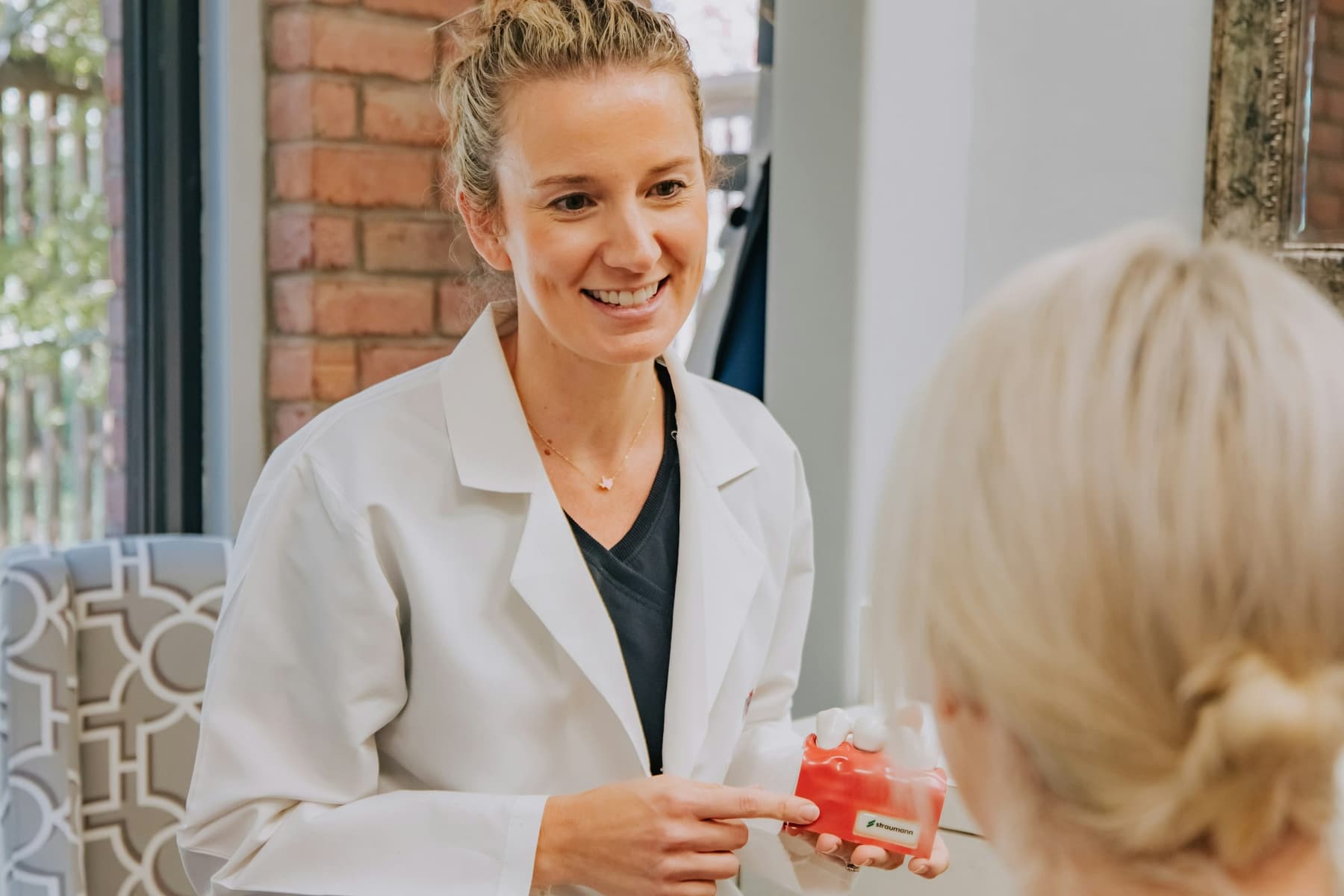 A Solenne provider talking with a client during a consultation